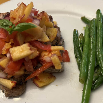 pineapple mango salsa on pork chop with green beans on the side