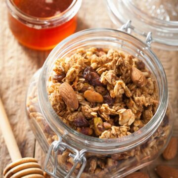 homemade healthy granola in glass jar and honey