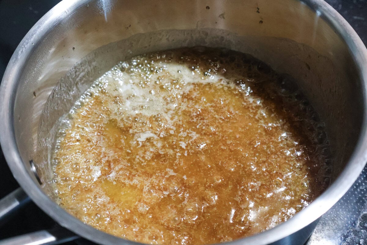 Butter melting with brown sugar in a pot.