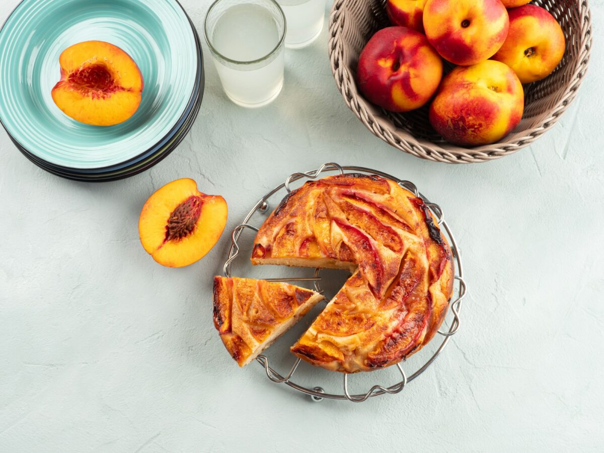 Vegan nectarine peach cake on turquoise table, summer treat