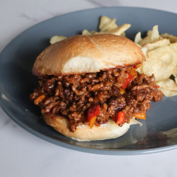 Sloppy Joe with chips on a gray plate.