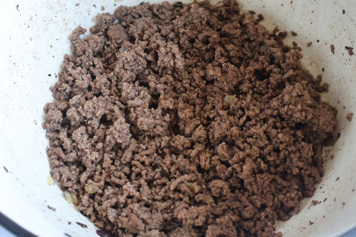 Cooked ground beef and onion in a Dutch oven.