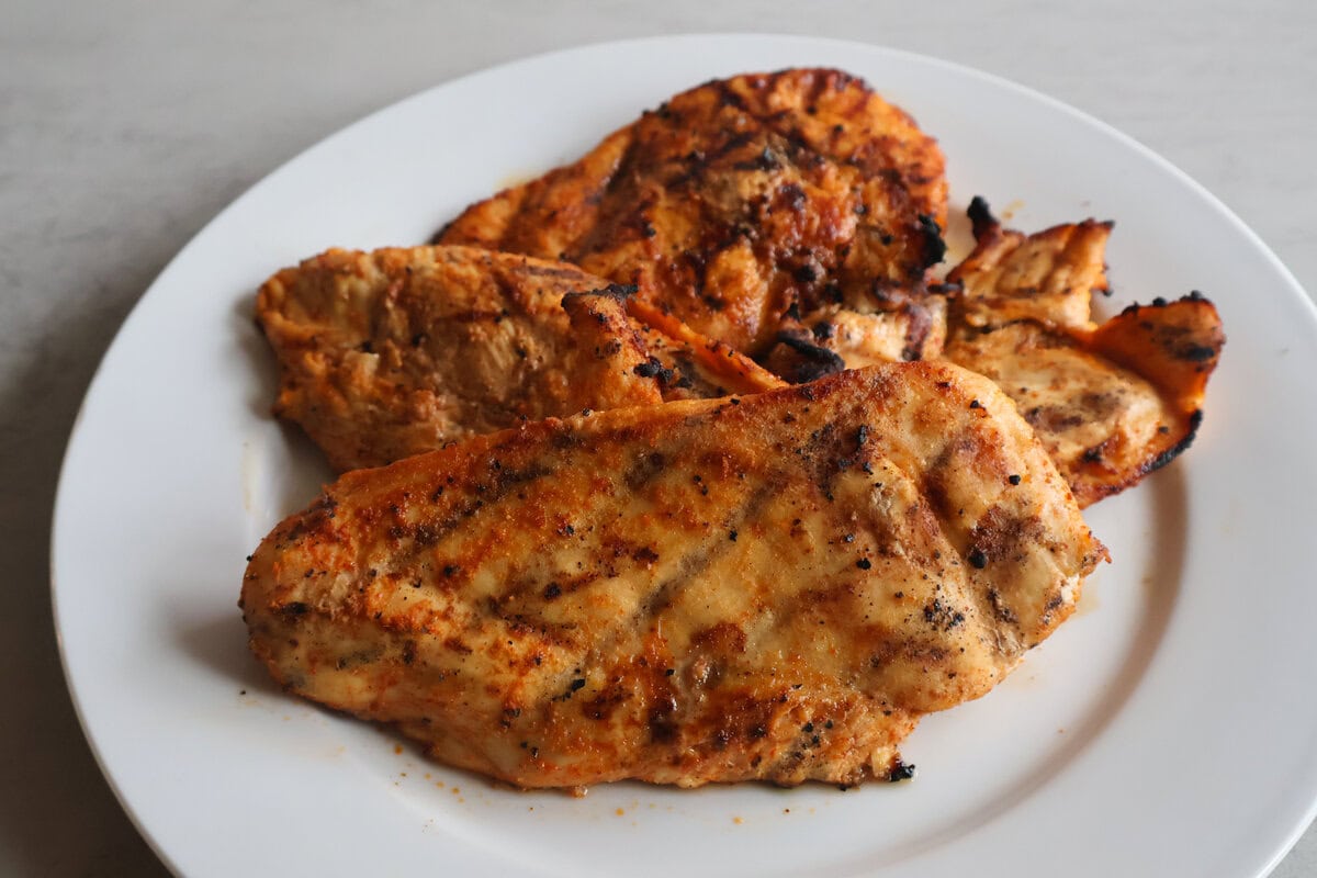 Grilled hot honey grilled chicken on a white plate.