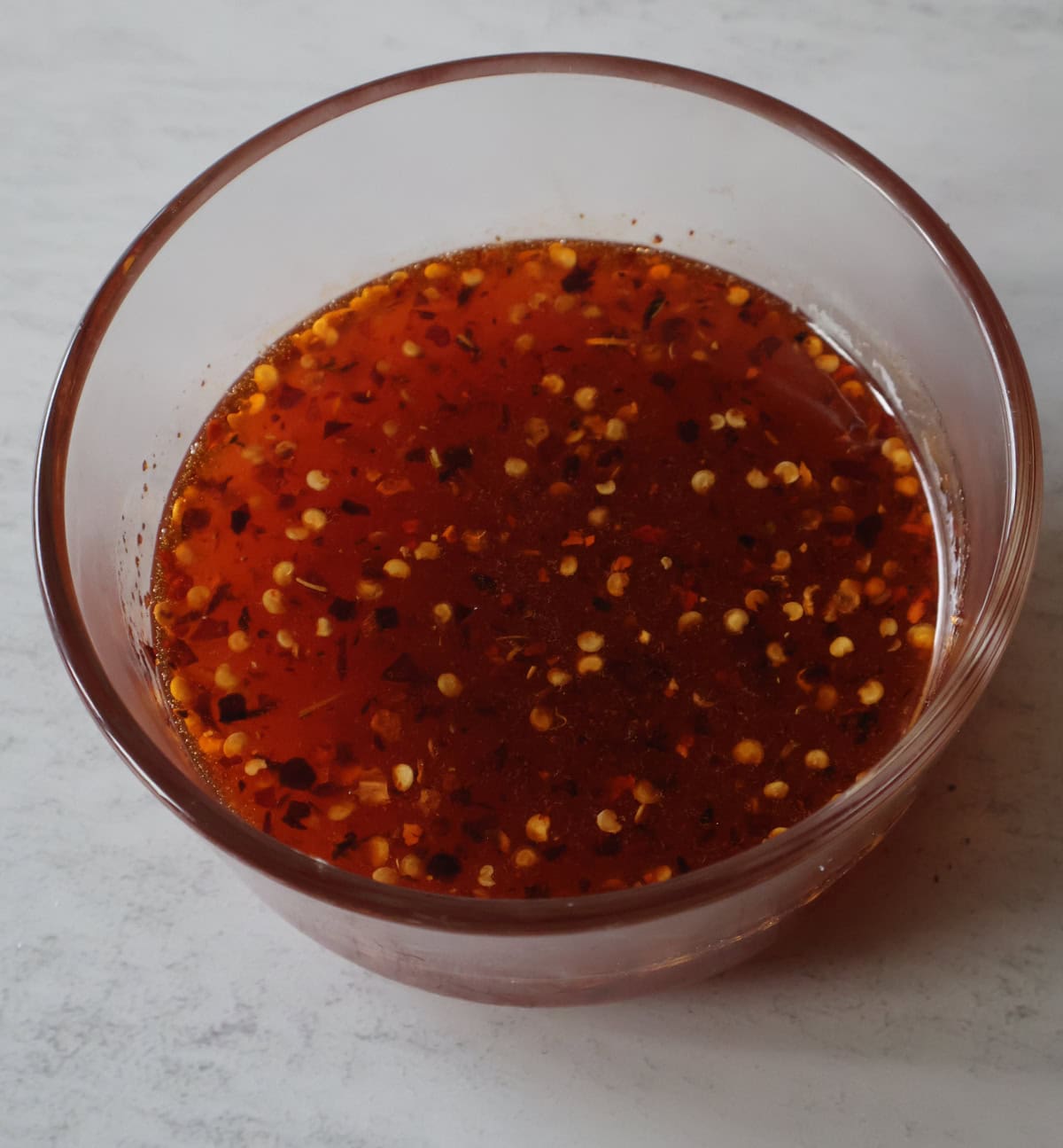 Hot honey marinade in bowl.