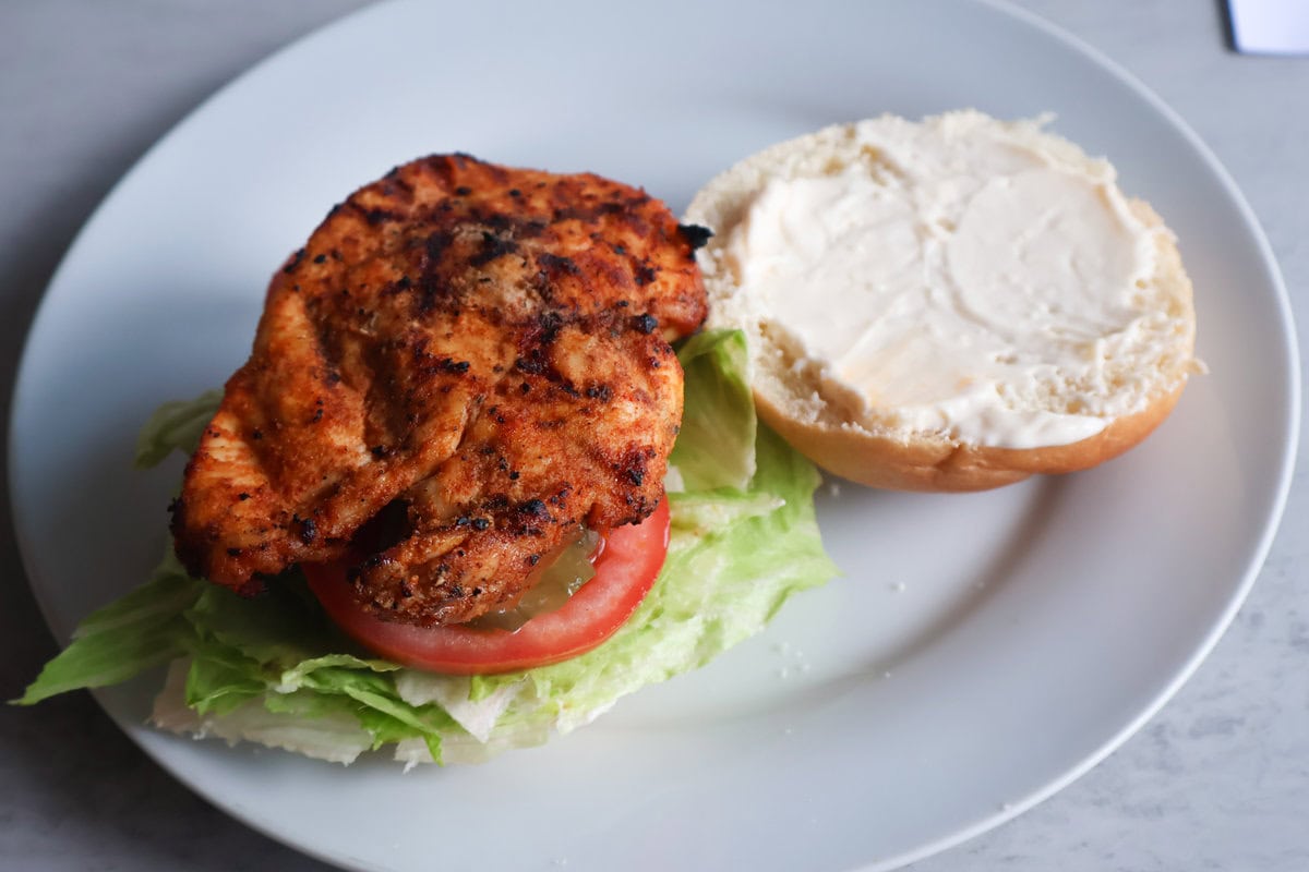 Hot honey chicken sandwich on plate.