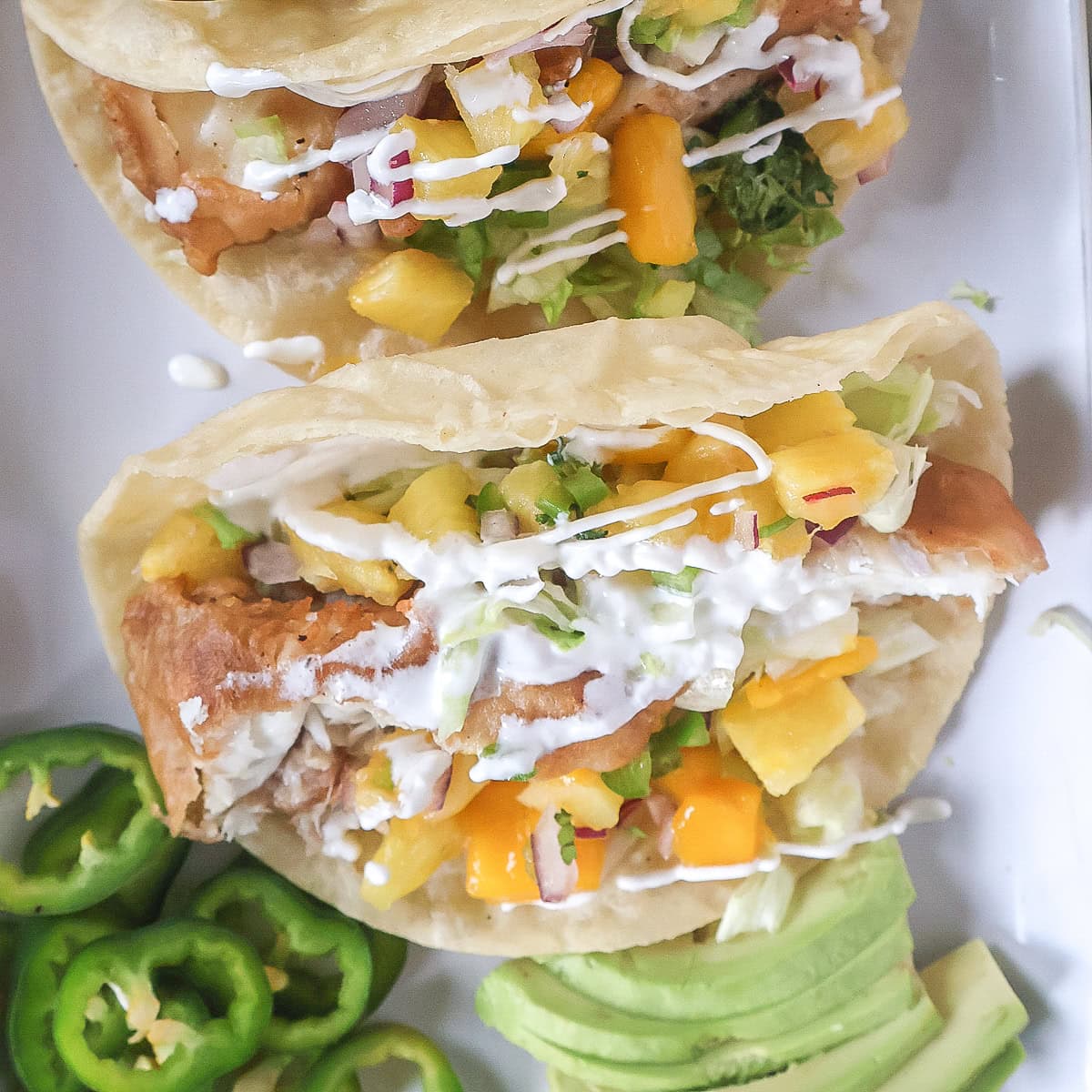 Crispy fish tacos with pineapple salsa and jalapenos.