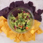Guacamole in a glass boel with tortilla chips