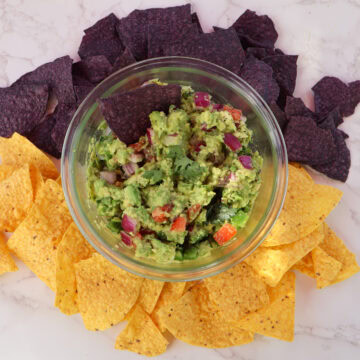 Guacamole in a glass boel with tortilla chips