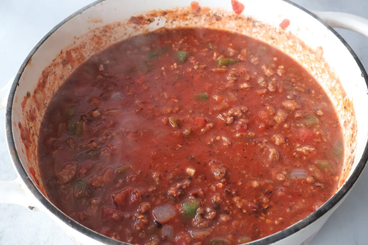 pizza chili ingredients simmering in a pot.