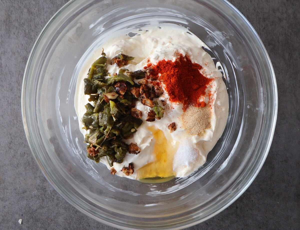 jalapeno chicken popper dip ingredients in a glass bowl.