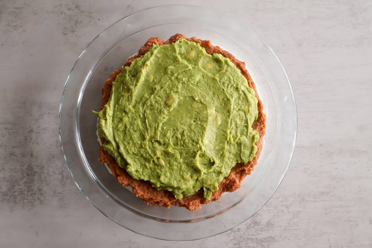 Layer of guacamole over the beans.