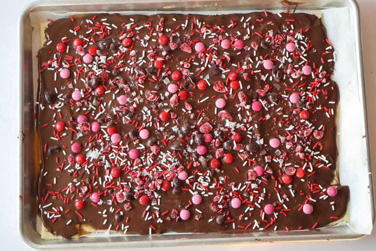 Chocolate layer on top with sprinkles and candy.