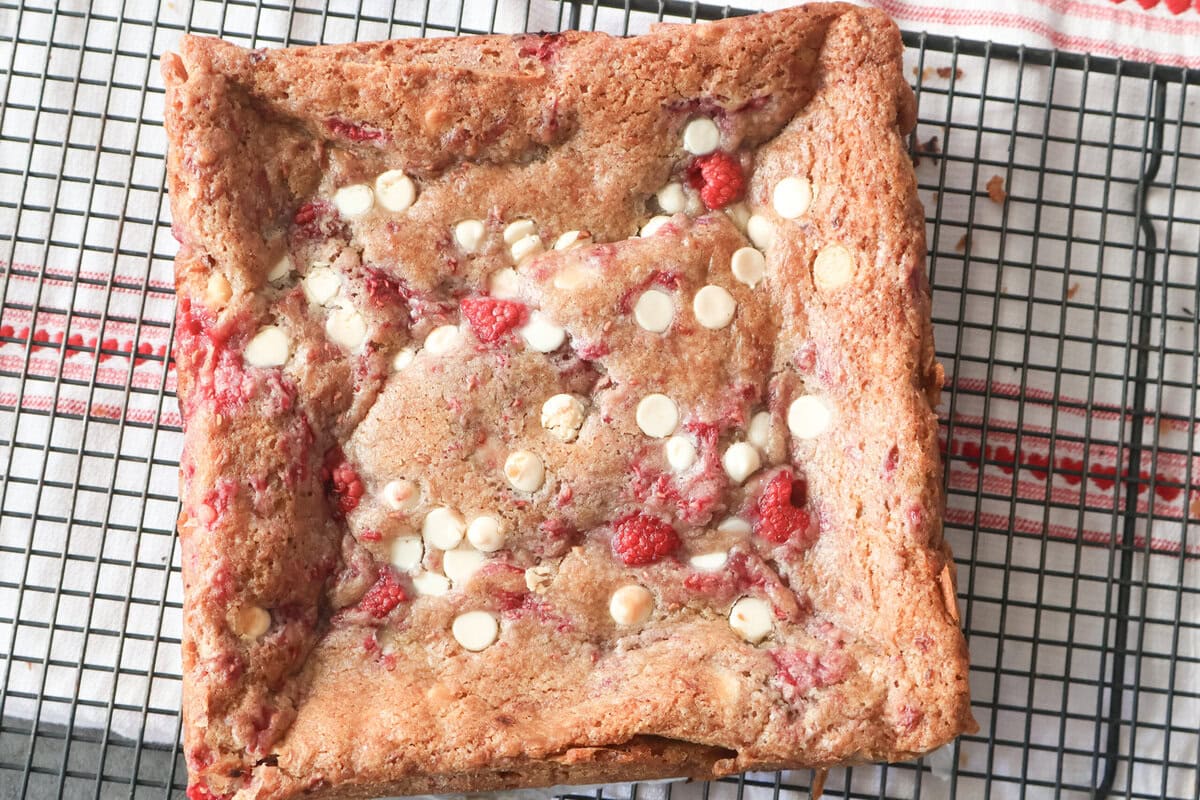 White chocolate raspberry blondies on a cooling rack.