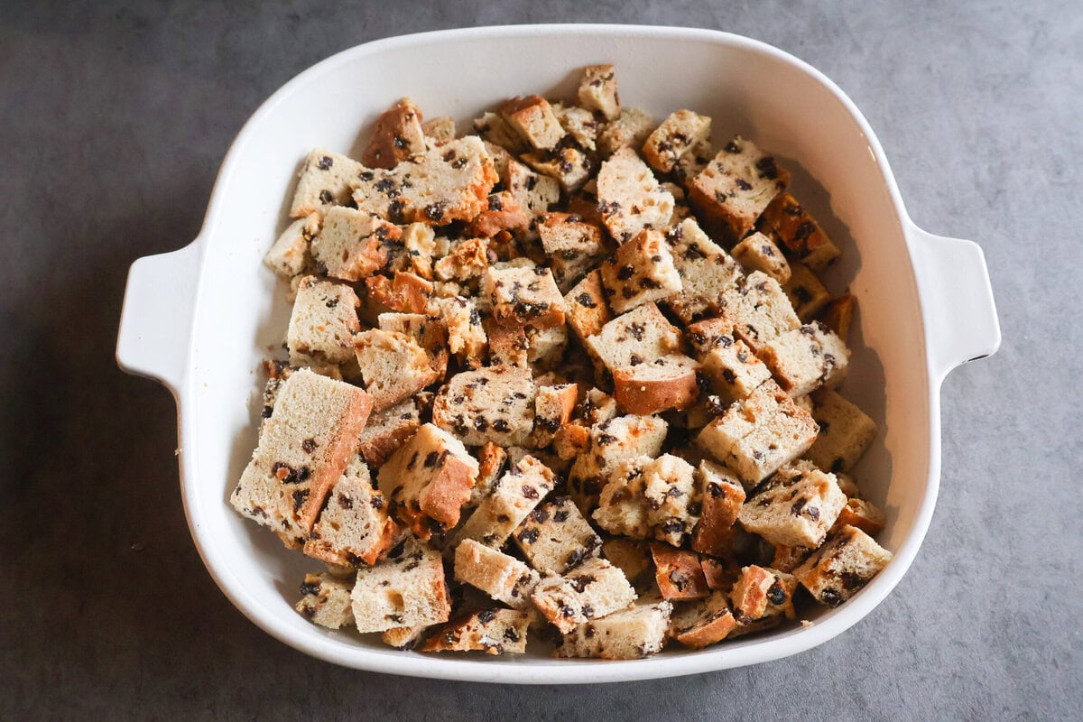 Cubed Irish Soda Bread in a white casserole dish.