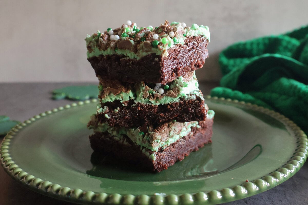 3 St. Patrick's Day Brownies on a green plate.