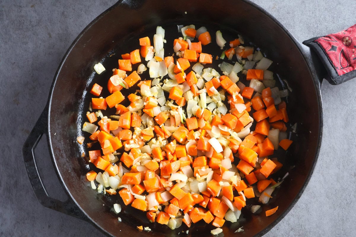 Carrots and Onions in a cast iron pan.