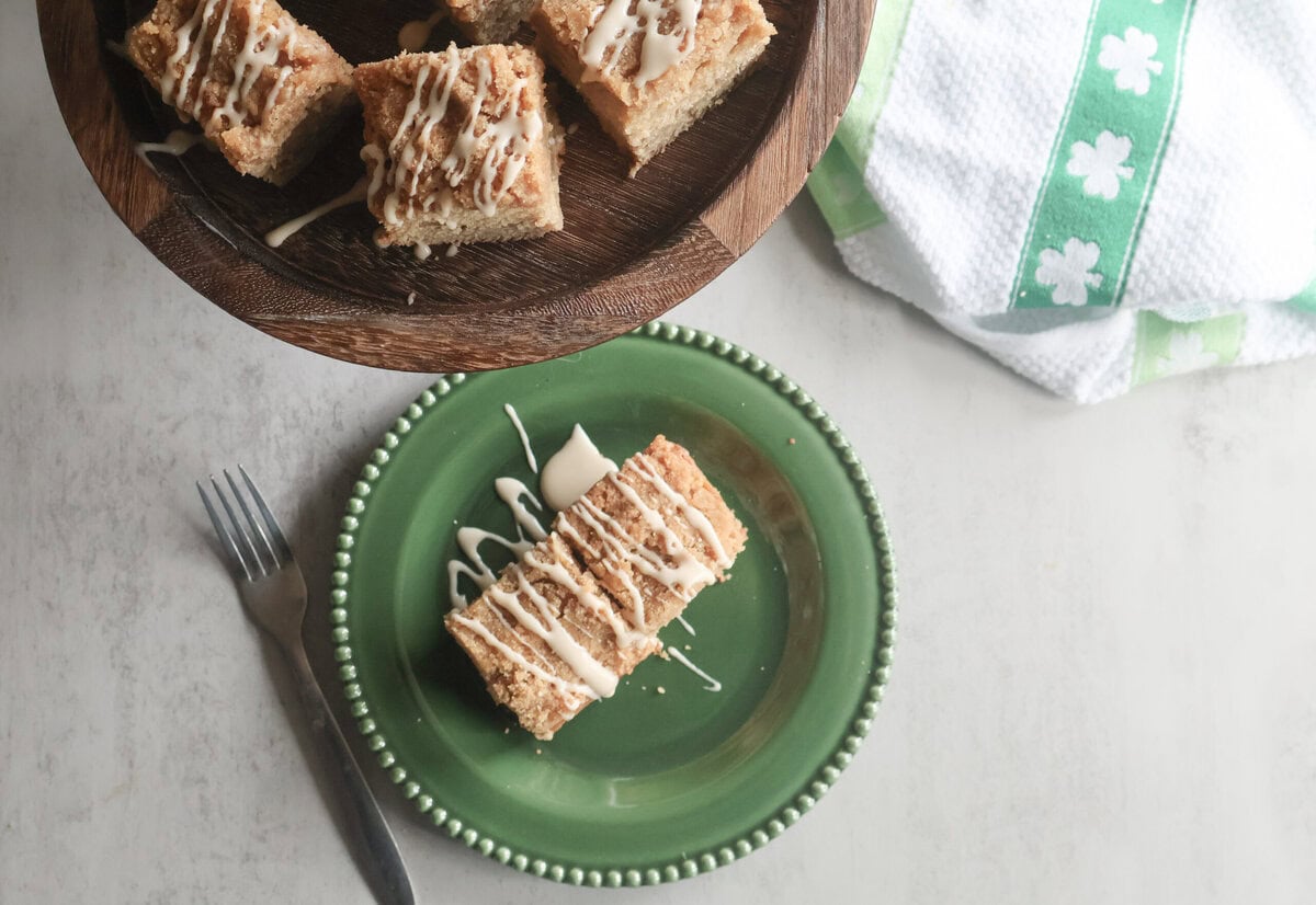 Slice of Irish Coffee Cake on a green plate with a fork.