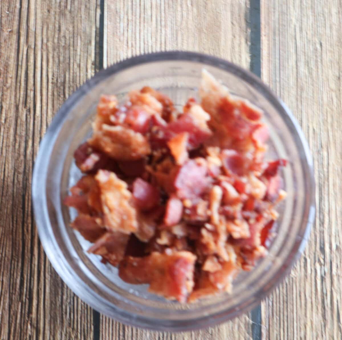 Crumbled Bacon in a small glass dish.