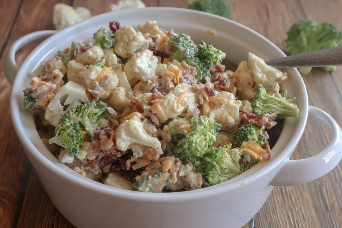 Creamy Cauliflower and Broccoli Salad in a white casserole dish.