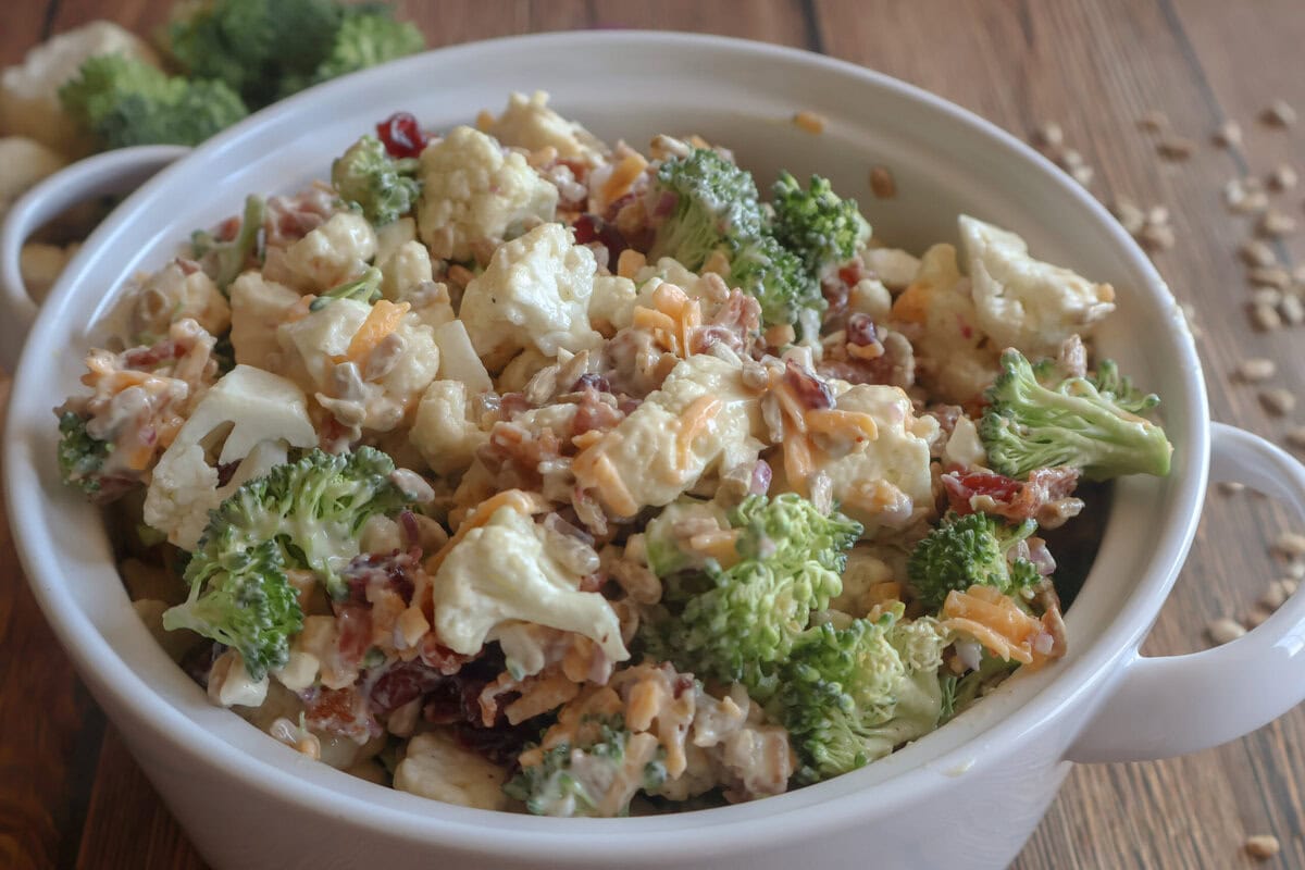 Creamy Cauliflower and Broccoli Salad in a white casserole dish.
