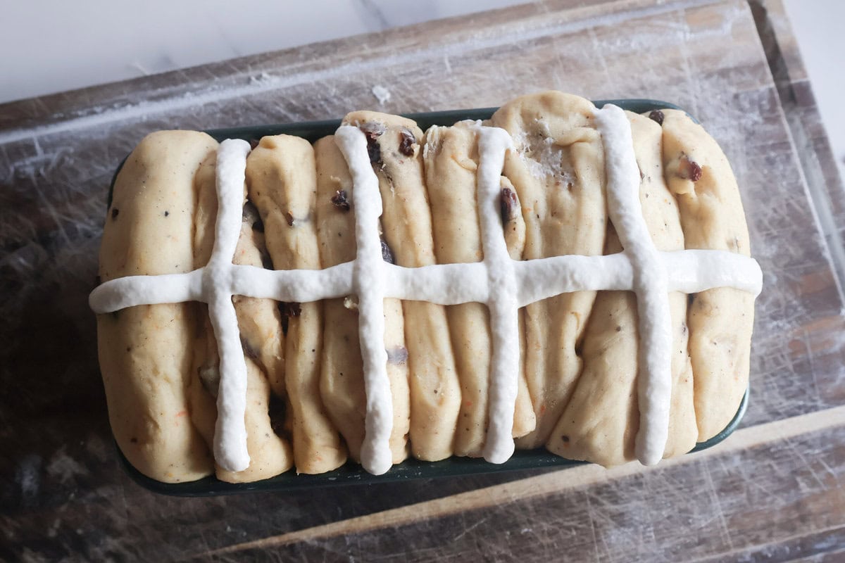 Baked Spiced Hot Cross Buns Loaf on a wire rack.