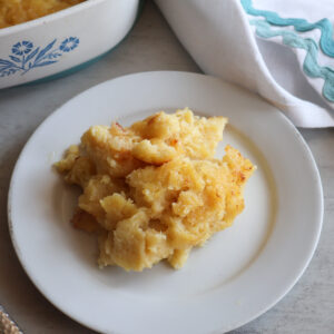 Baked pineapple on a white plate.