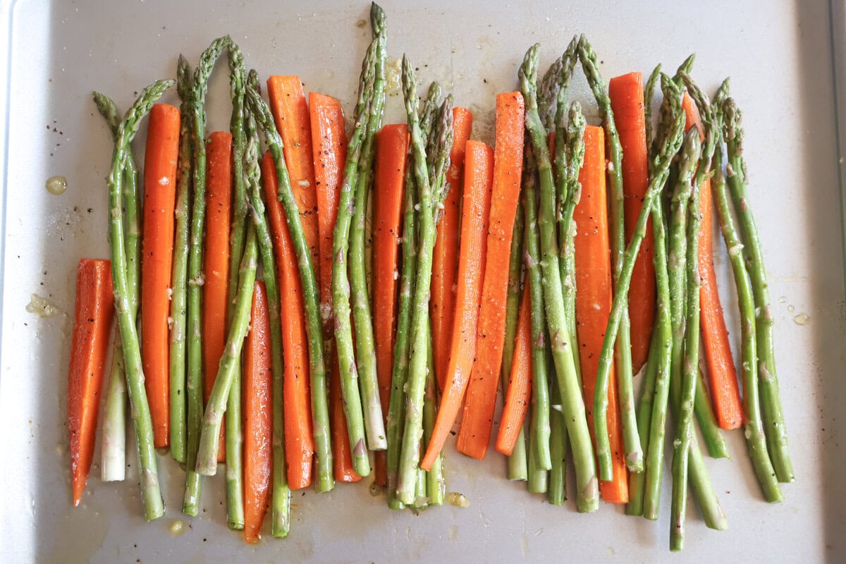 Asparagus and carrots on a baking sheet.