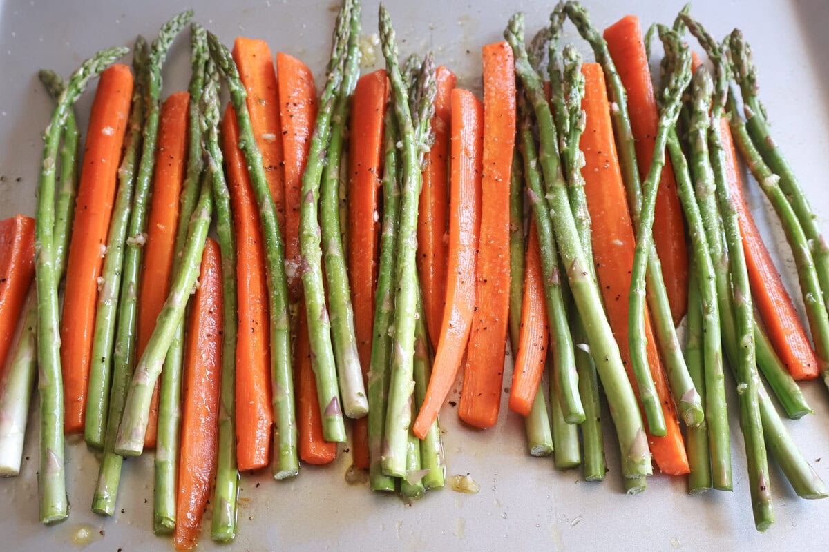Asparagus and carrots on a baking sheet.