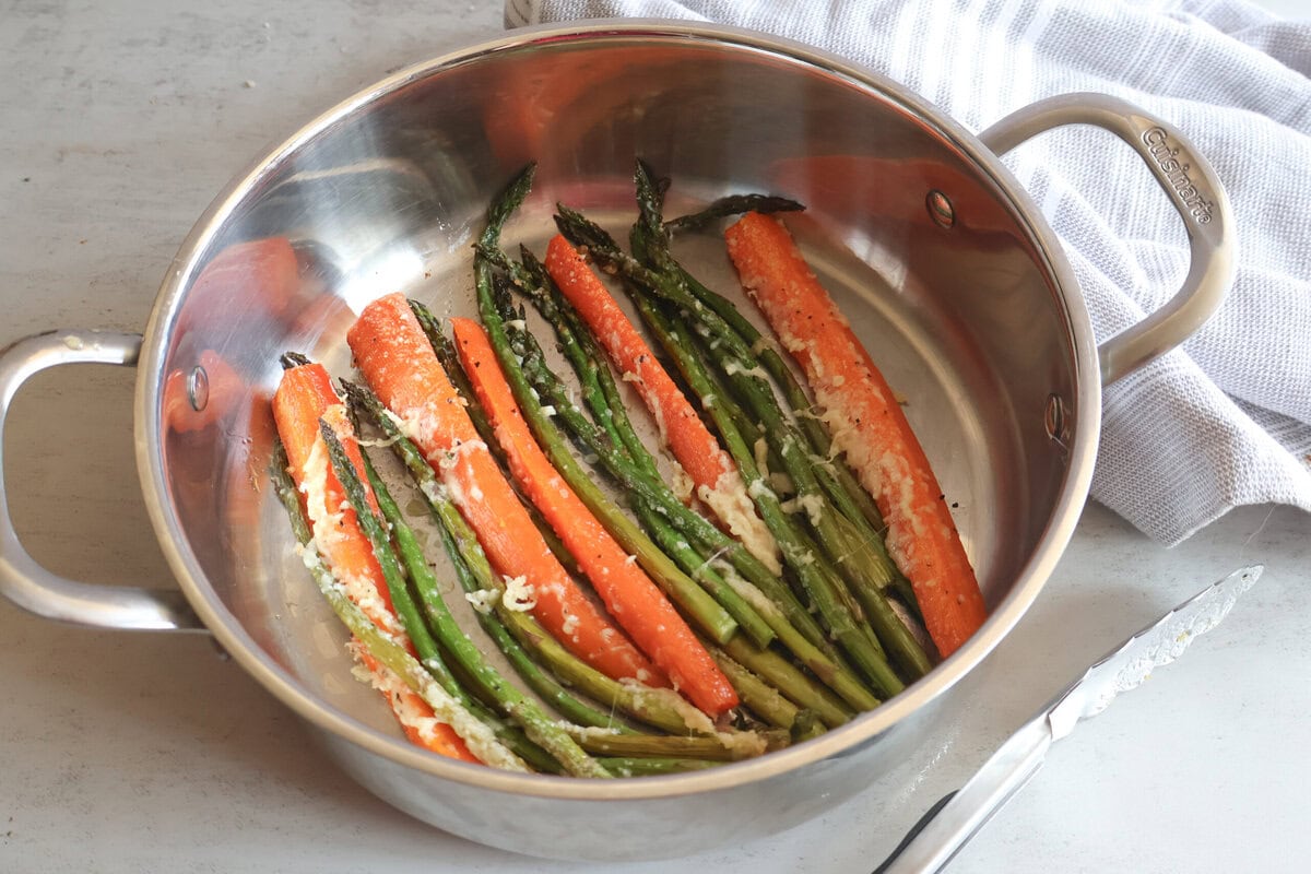 Honey garlic roasted asparagus and carrots in a pan.