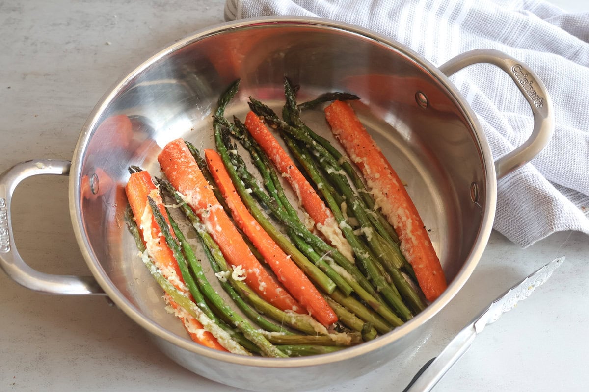 Honey garlic roasted asparagus and carrots in a pan.