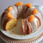 Mandarin orange bundt cak on a white plate.