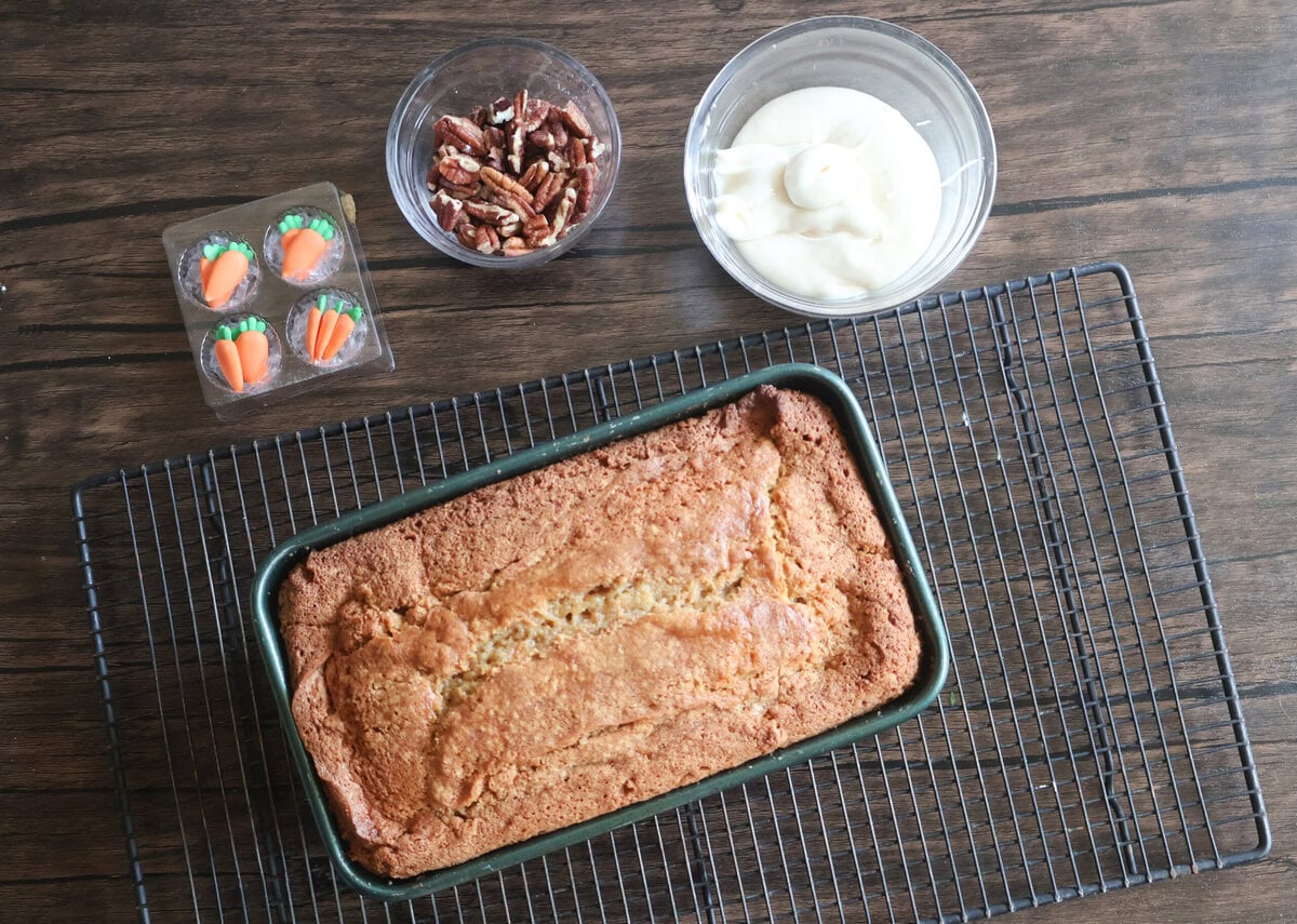 Carrot cake pound cake with cream cheese frosting and toppings.