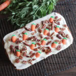 Iced carrot cake pound cake with nuts.