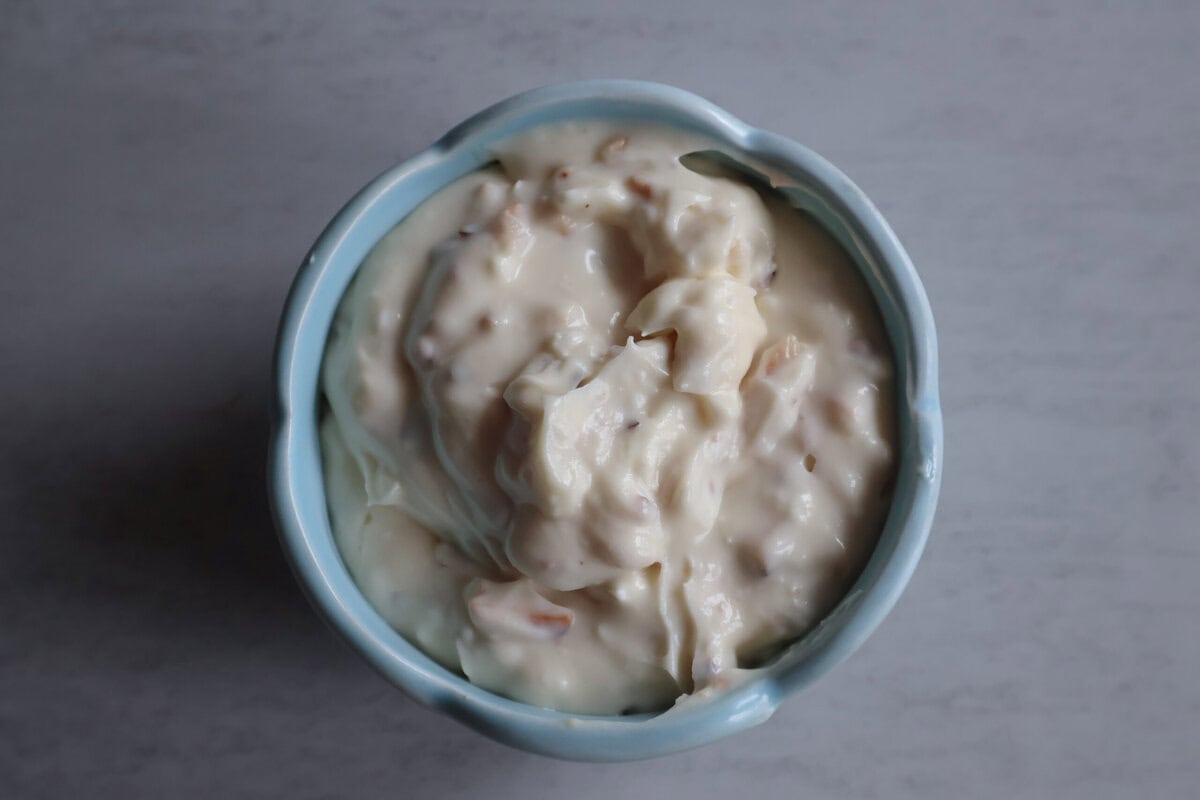 Honey almond cream cheese in a blue bowl.