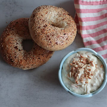 Honey Almond Cream Cheese with bagels and pink and white striped towel.