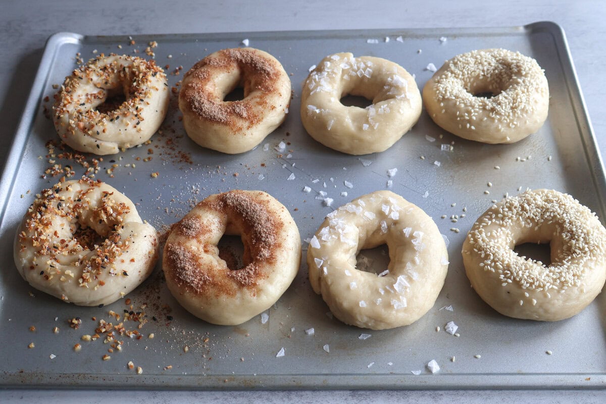 Bagels with toppings ready to bake.
