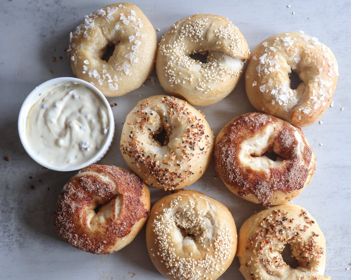 Bagels with a ramekin of cream cheese.