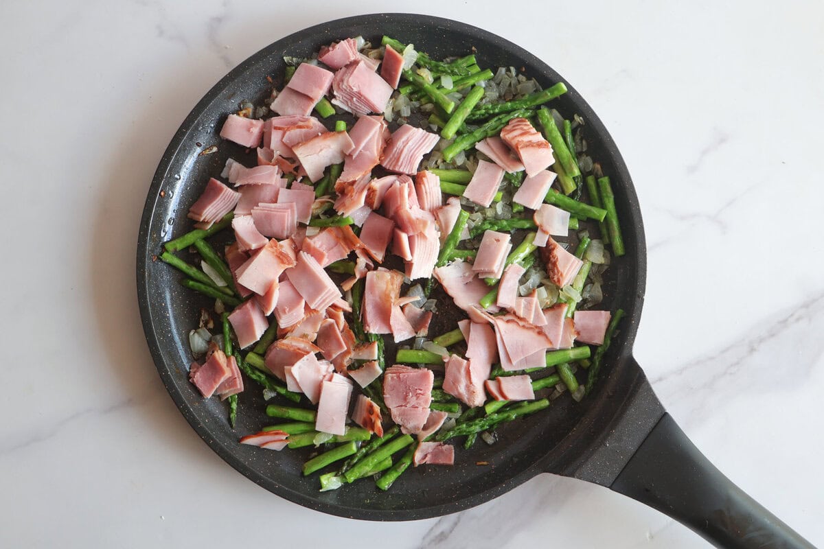 ham and asparagus in a pan.