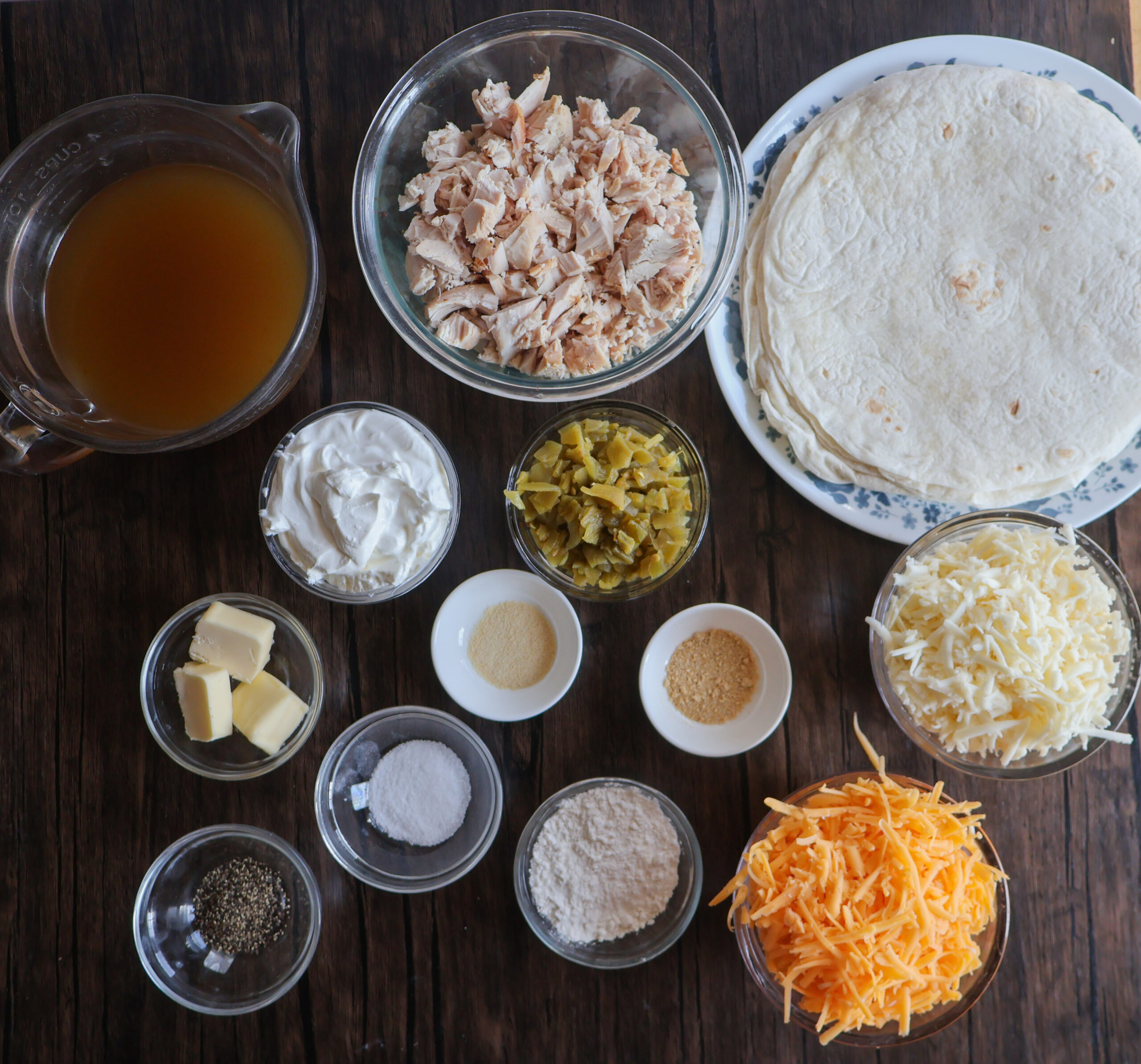 Ingredients for creamy chicken enchiladas with sour cream sauce.