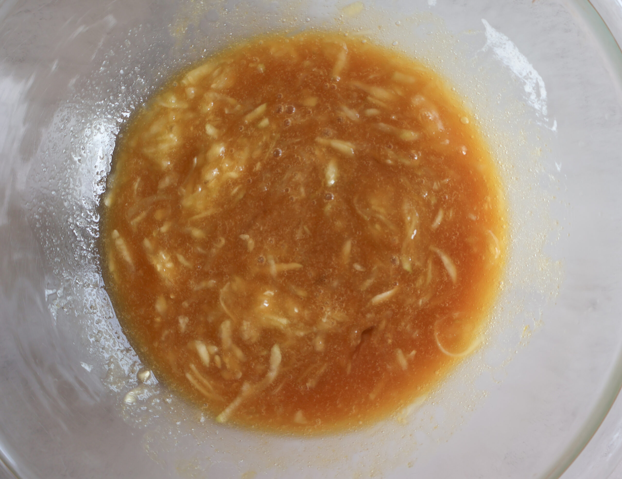 Wet ingredients added to a glass bowl.