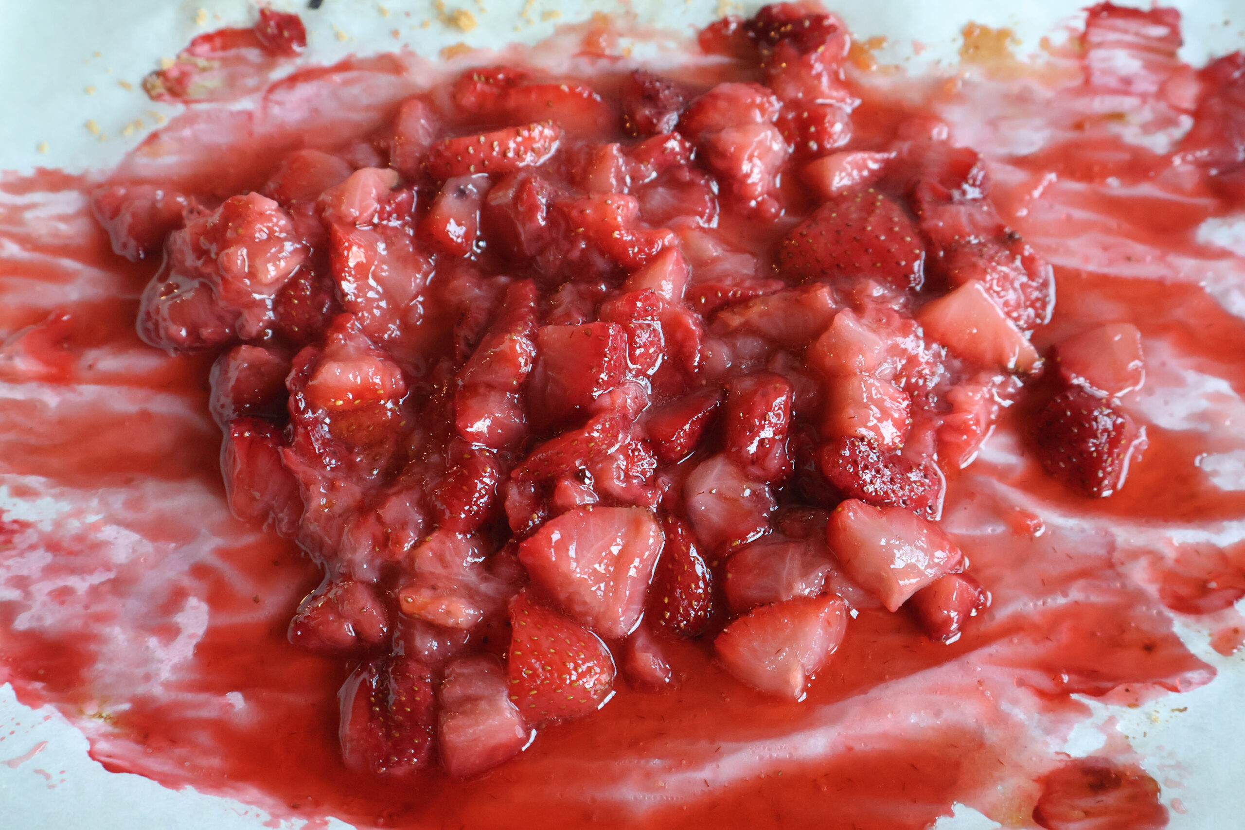 Roasted strawberries on a sheet pan.