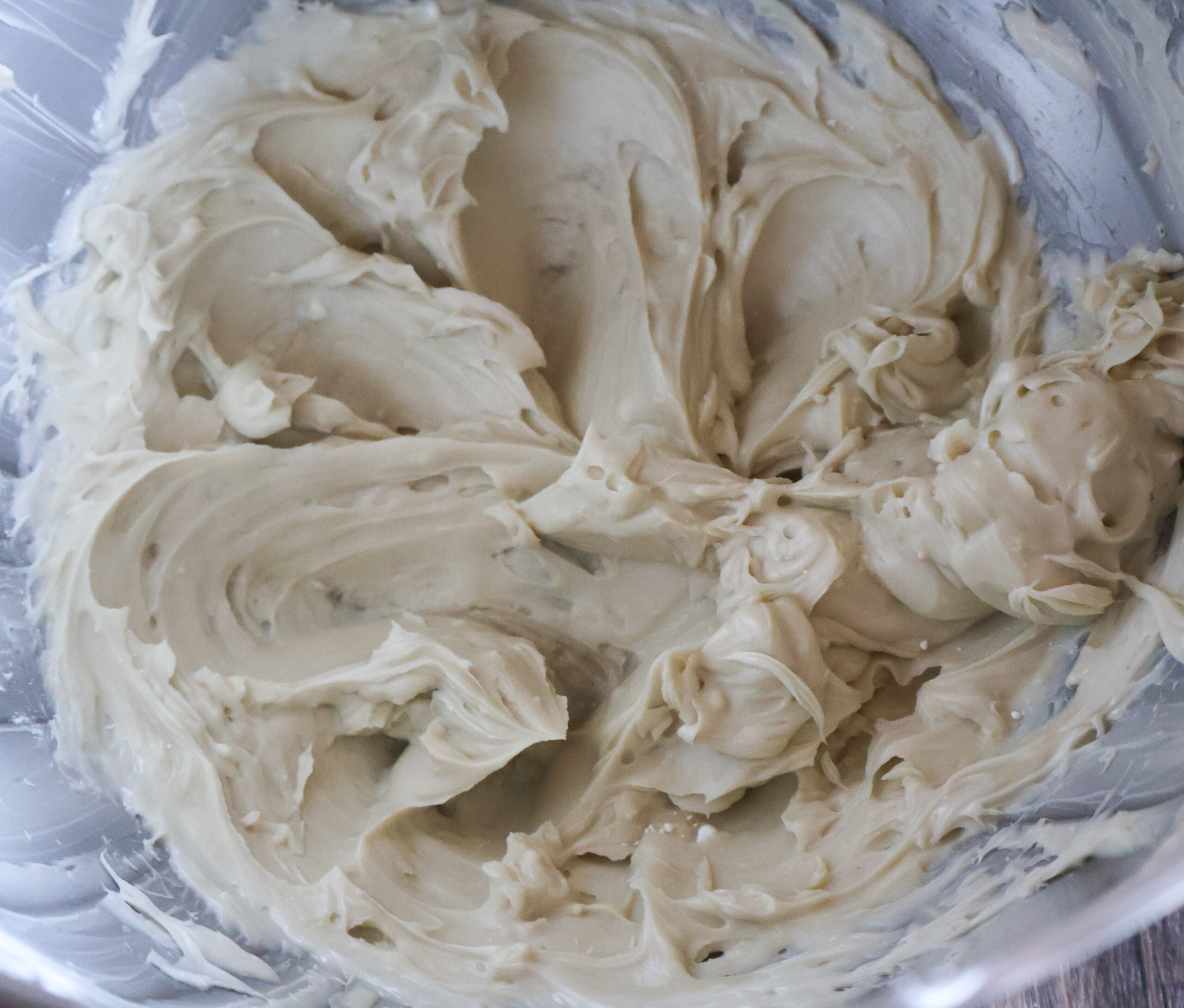 Whipped butter with ingredients in a mixing bowl.