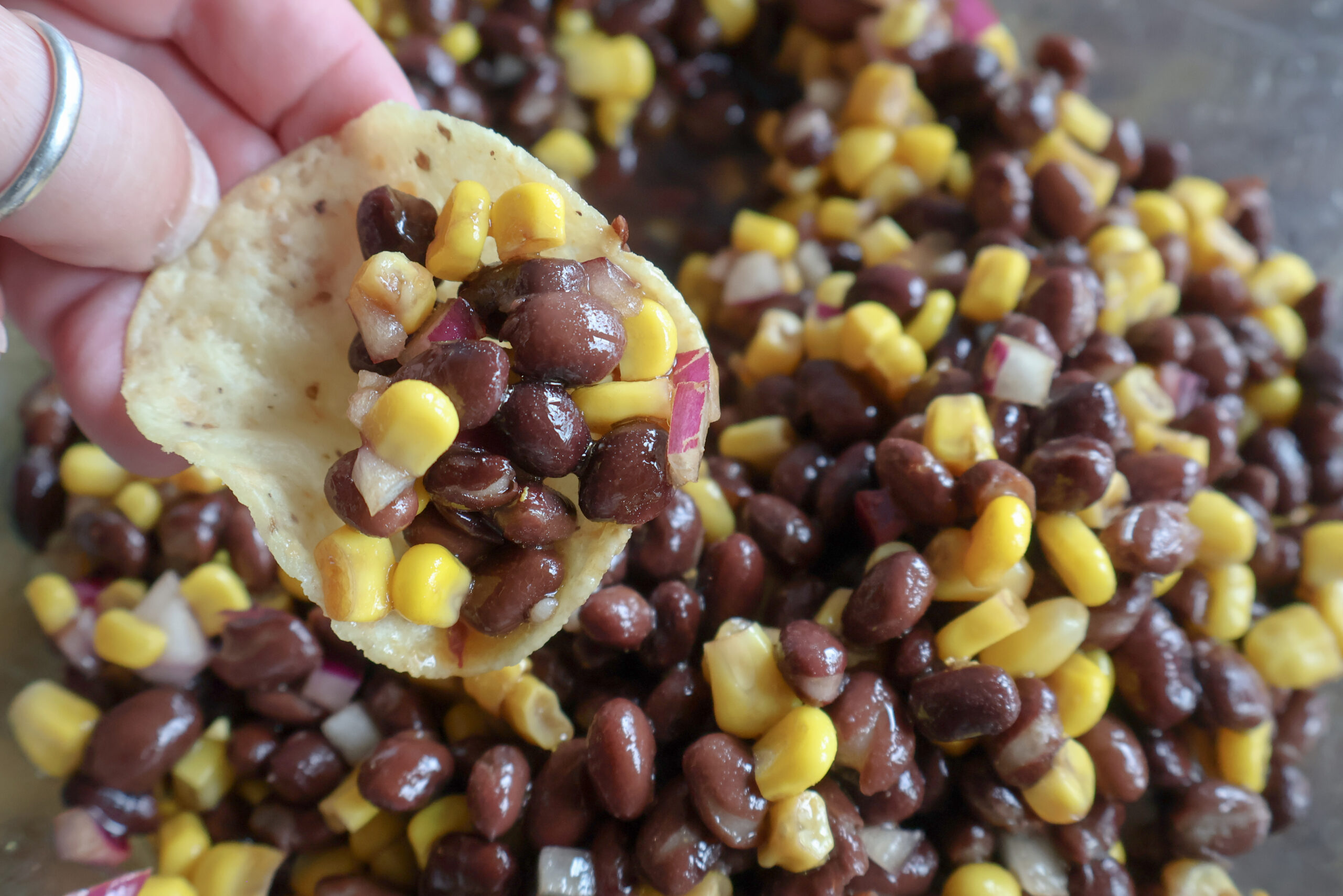 Black bean and corn dip with a chip.