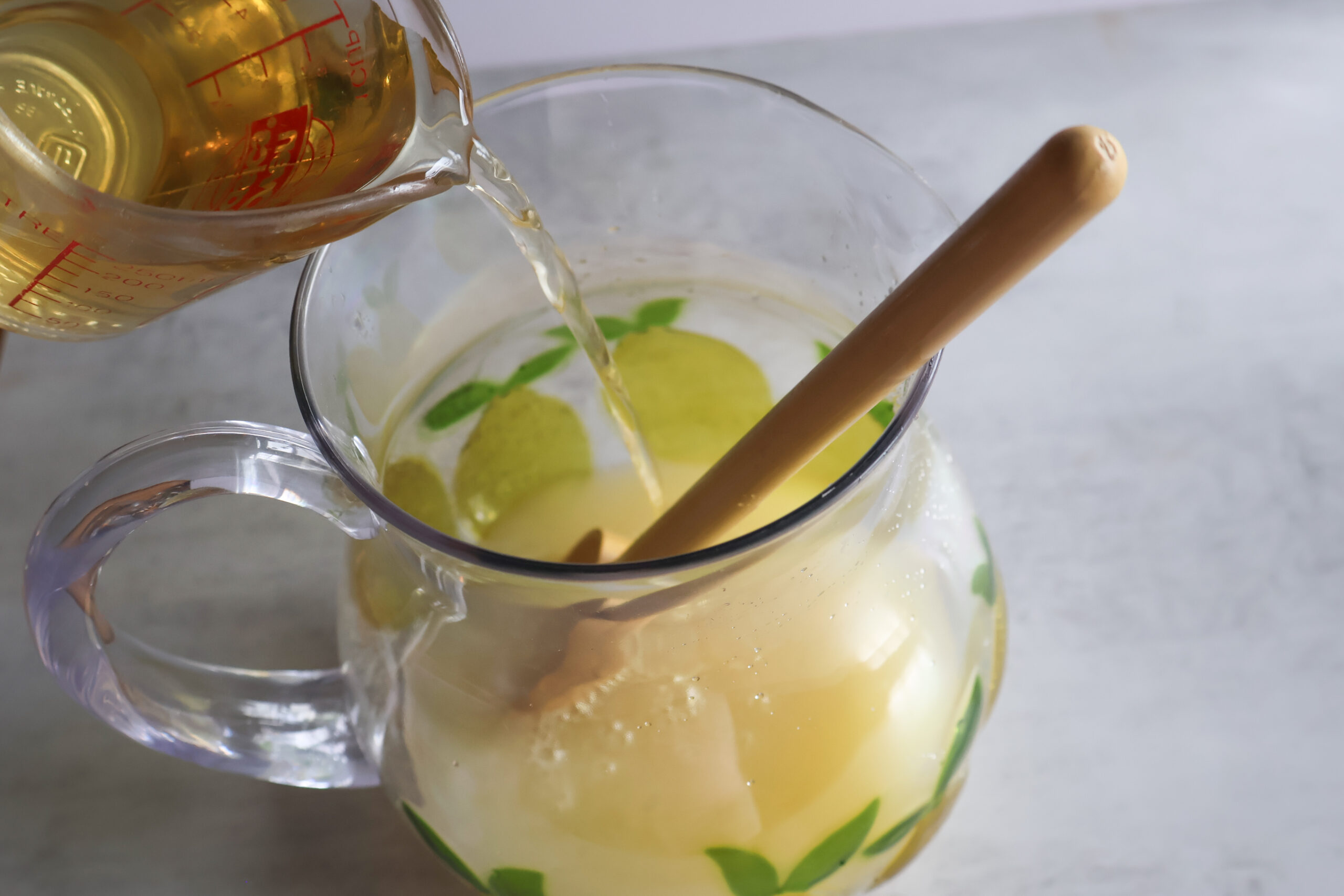 White grapr juice being added to the summertime cooler.
