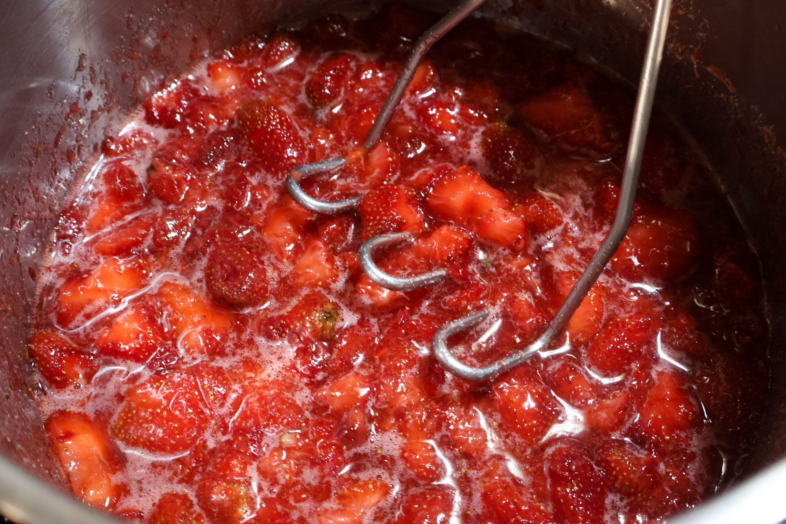 slightly mashing the honey strawberry preserves.