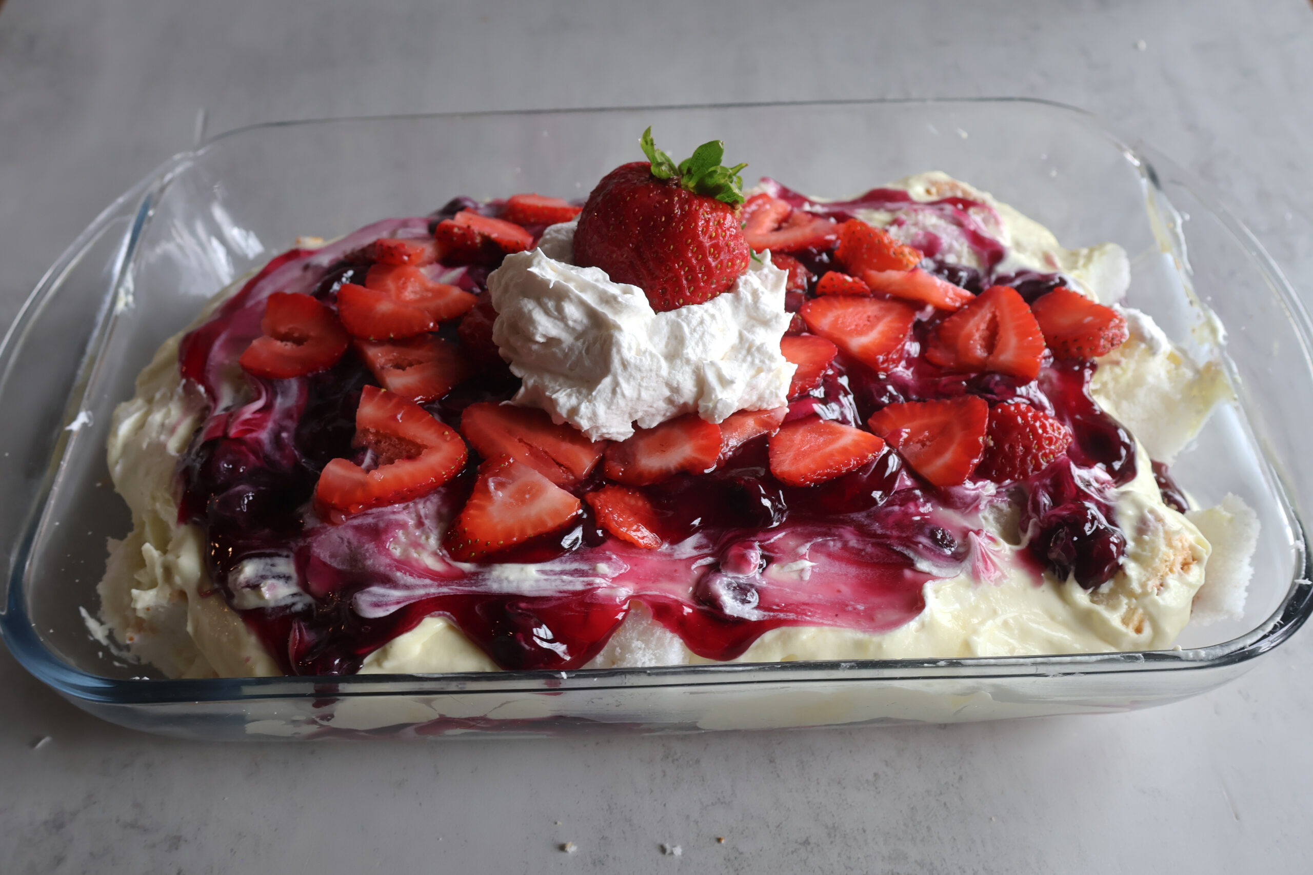 Lemon berry cloud dessert in a glass dish.
