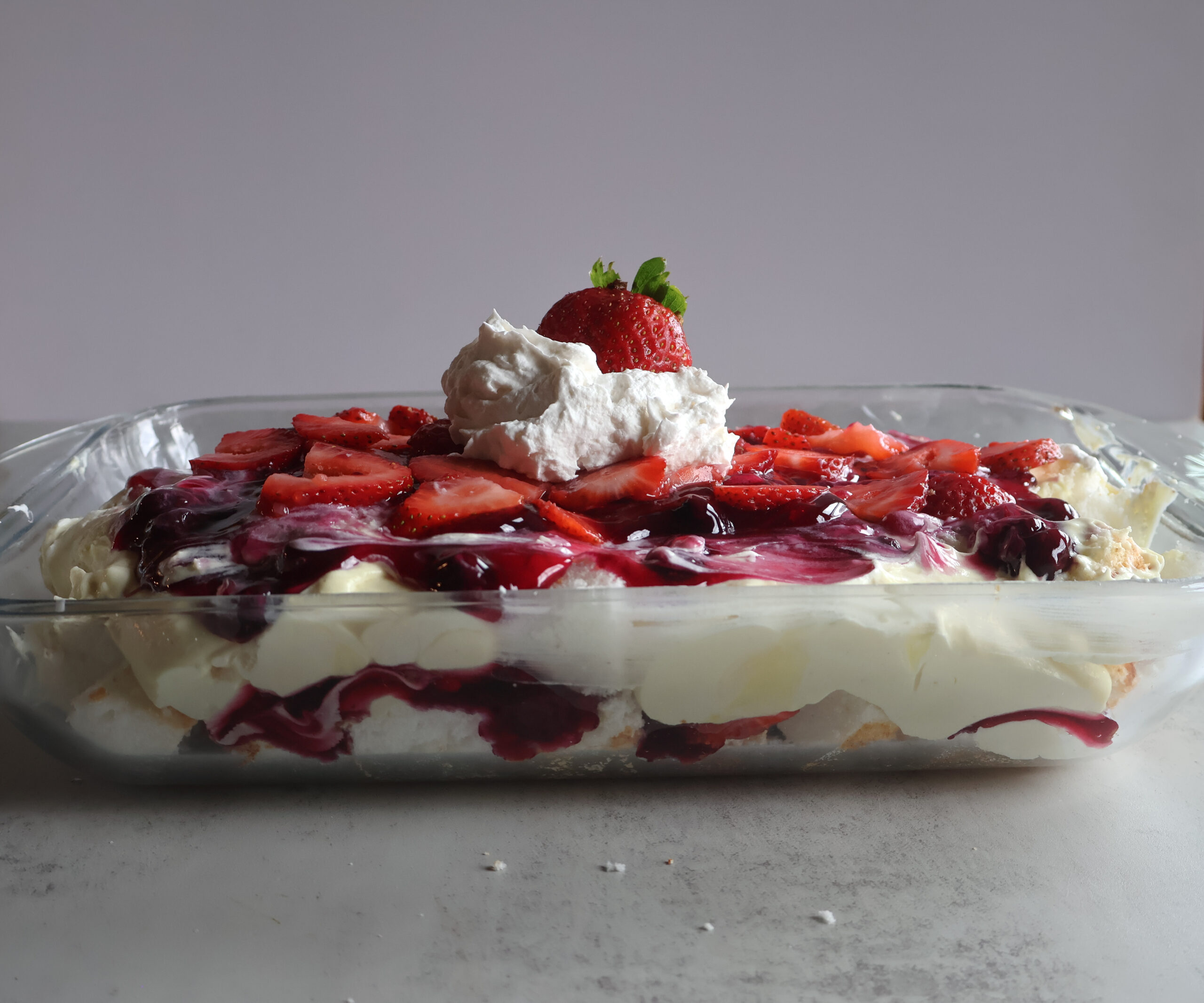 Lemon Berry Cloud Dessert in a glass dish.