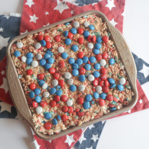 Patriotic M&M Rice Krispie Treats in a square pan.