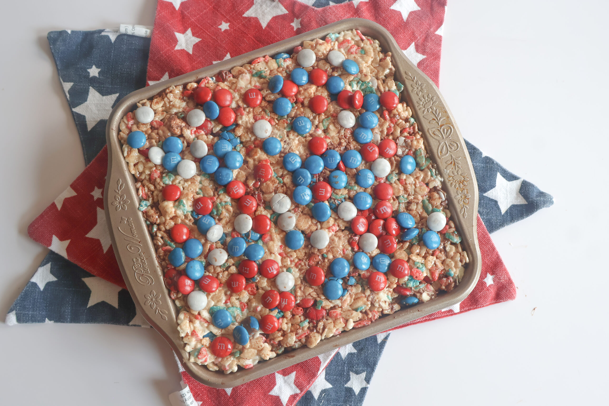 patriotic M&M Rice Krispie Treats in a square pan with star placemats.