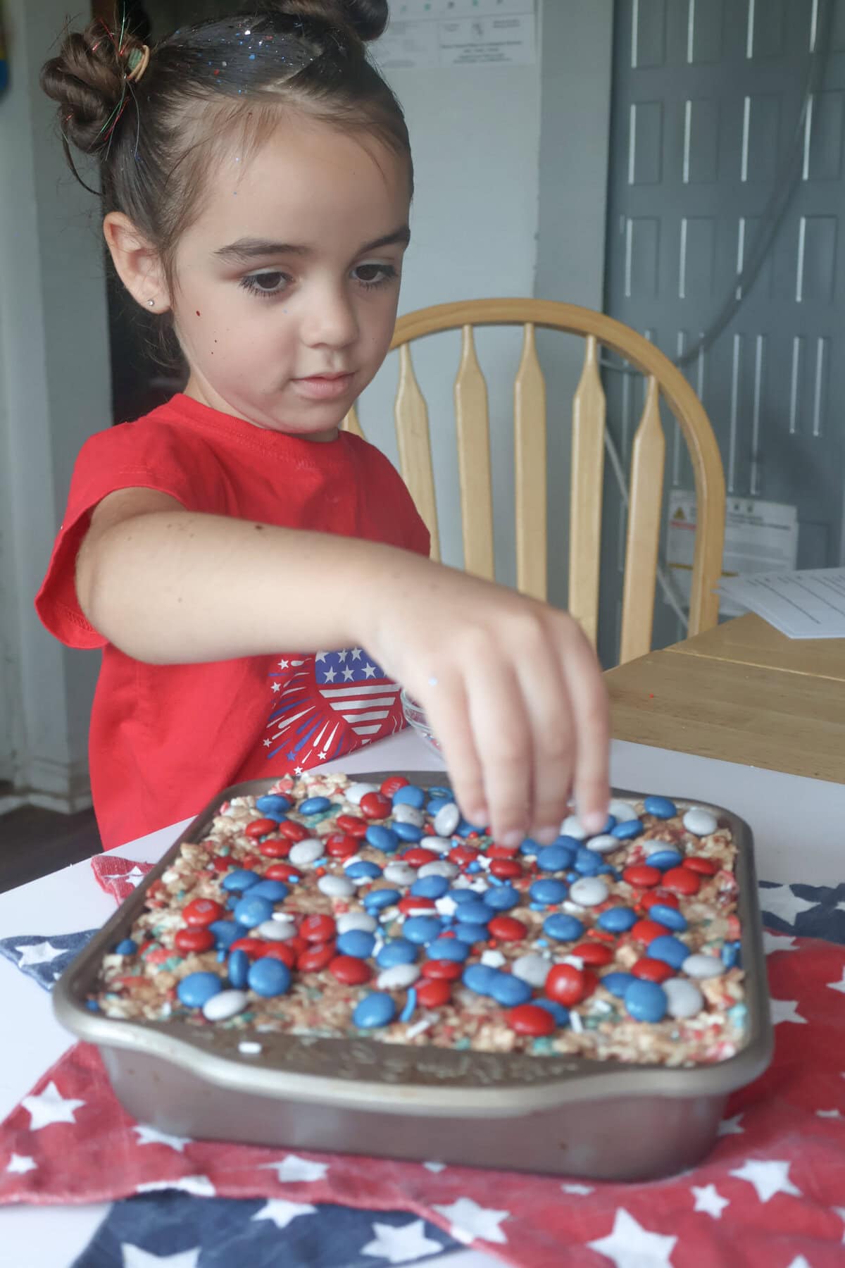 My daughter decorating the rice krispie treats.